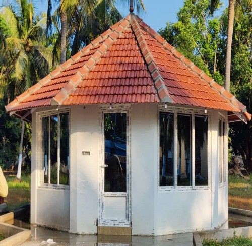 compact security cabin with uPVC windows and glass door surrounded by greenery