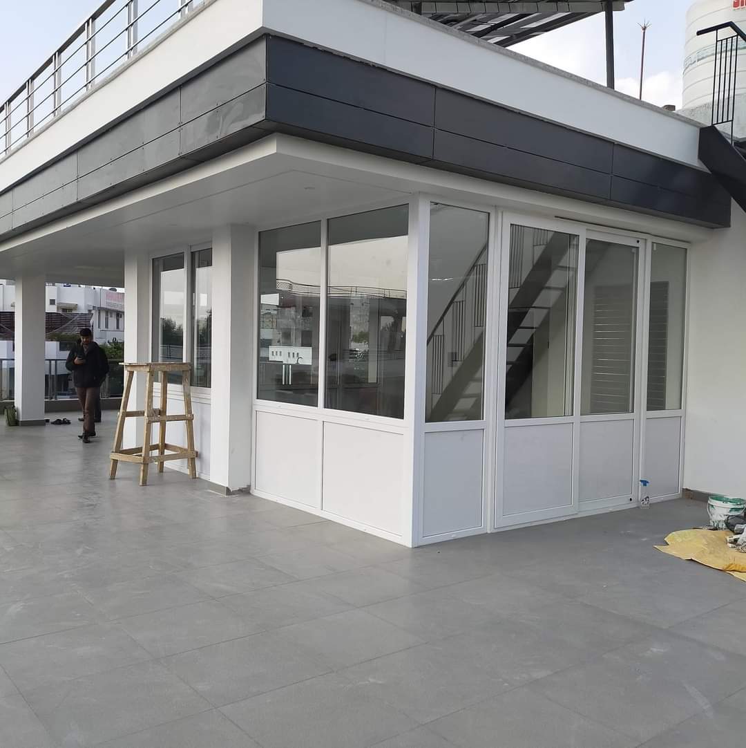 uPVC terrace enclosure installation with glass windows and doors in residential building